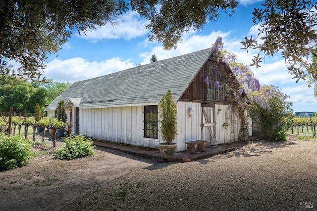 view of barn with fence