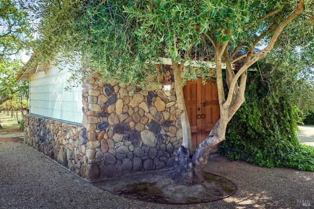 exterior space with stone siding