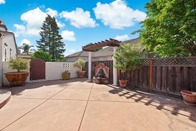 view of patio / terrace with a gate, a pergola, and fence