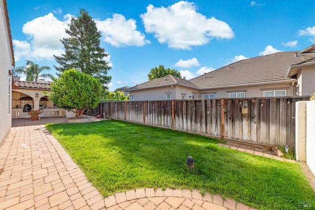 view of yard featuring a patio and a fenced backyard