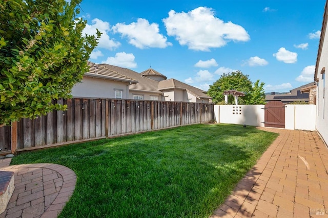 view of yard with a gate and a fenced backyard