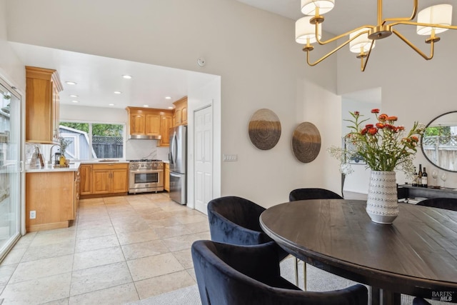 dining area with recessed lighting, a high ceiling, and an inviting chandelier