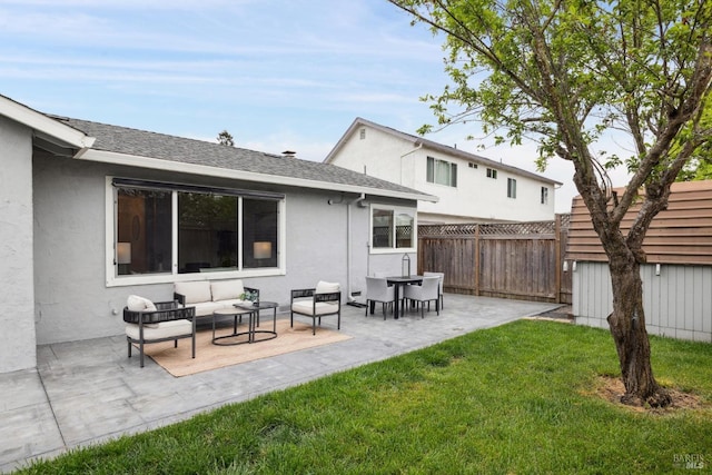 back of property with stucco siding, a fenced backyard, an outdoor living space, a patio, and a yard