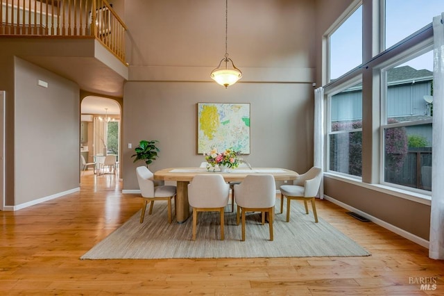 7580 Meadowlark Dr, Sebastopol, CA 95472 - dining space with baseboards, arched walkways, wood finished floors, and a high ceiling