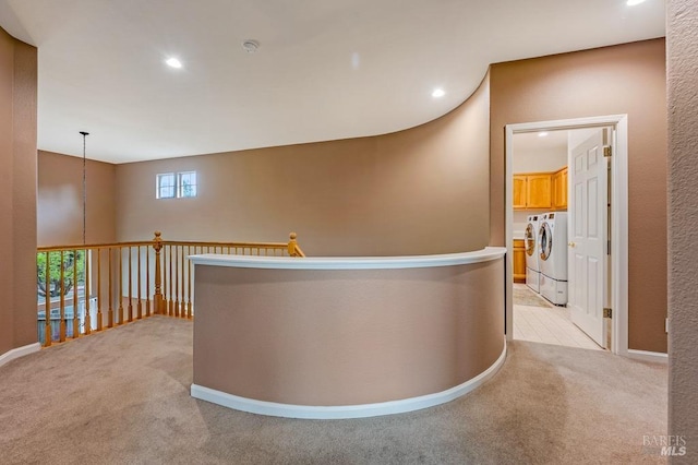 hall featuring baseboards, washing machine and clothes dryer, recessed lighting, and light colored carpet
