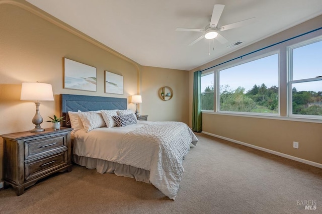 bedroom featuring light colored carpet, baseboards, ceiling fan, and visible vents