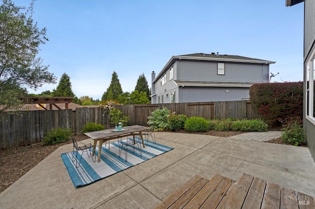 exterior space featuring a fenced backyard and outdoor dining area