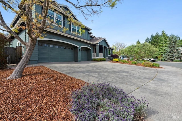 traditional-style home featuring fence, an attached garage, and driveway