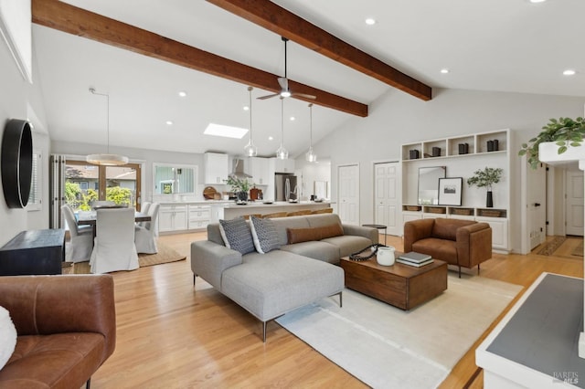 living room featuring vaulted ceiling with beams, a ceiling fan, recessed lighting, and light wood-style flooring