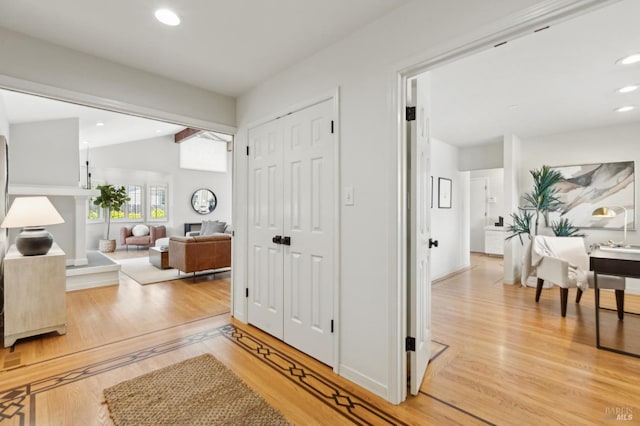 foyer with recessed lighting, vaulted ceiling, and light wood-type flooring