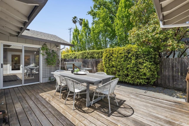 wooden deck with fence and outdoor dining area