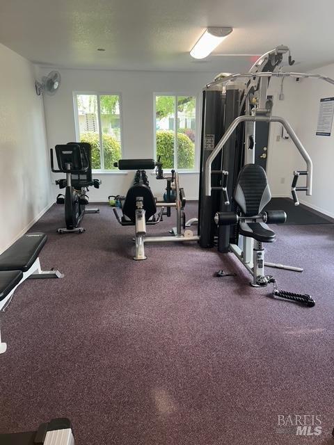 workout area featuring baseboards