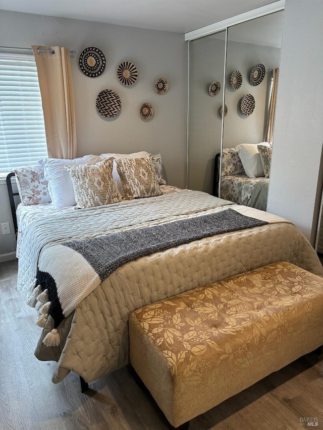 bedroom with a closet and wood finished floors