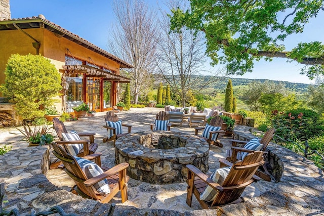 view of patio / terrace with a pergola and an outdoor fire pit