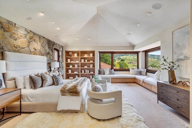 bedroom with vaulted ceiling and light carpet