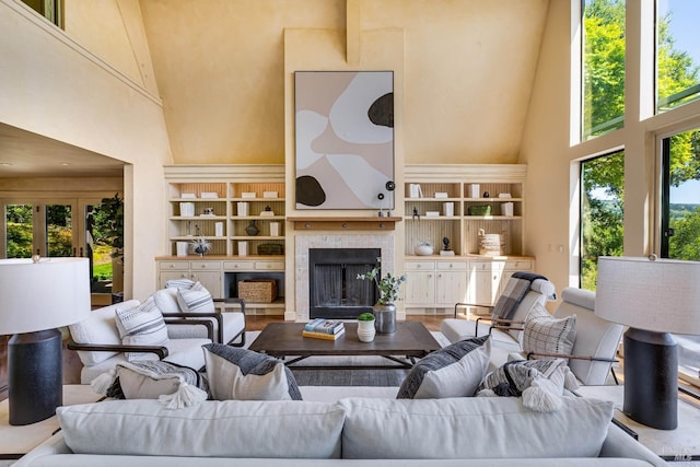 living room with a high ceiling and a fireplace