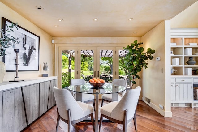 dining room featuring recessed lighting, visible vents, french doors, and light wood-type flooring