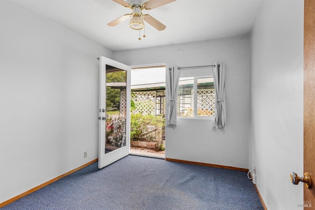 empty room with carpet floors, baseboards, and ceiling fan
