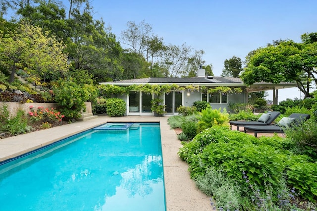 view of swimming pool with a pool with connected hot tub