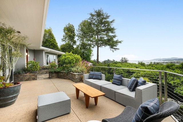 view of patio / terrace with a mountain view, outdoor lounge area, and a balcony