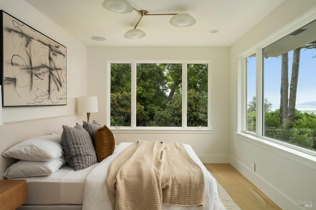 bedroom with light wood-style floors and baseboards