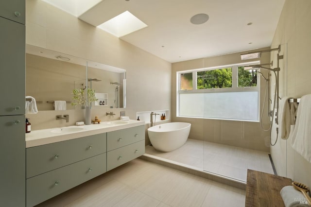 bathroom with double vanity, a sink, a walk in shower, and a soaking tub