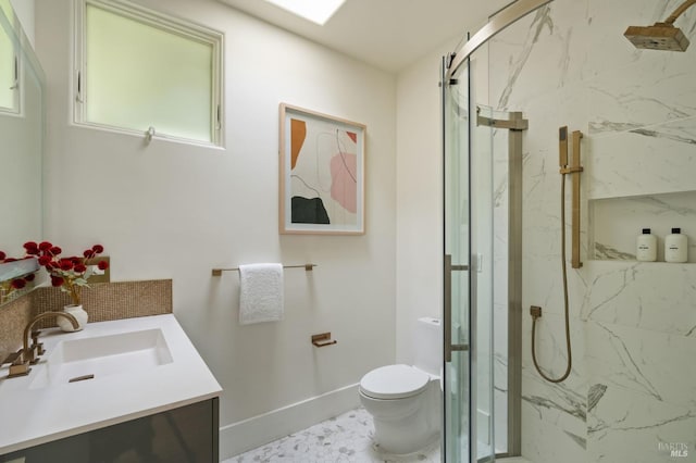 full bathroom featuring a marble finish shower, baseboards, vanity, and toilet