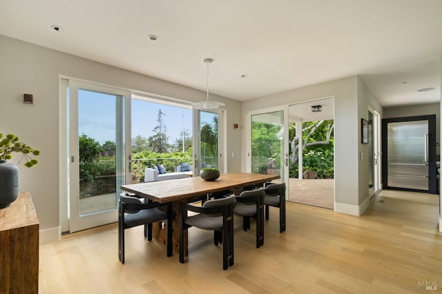 dining area with light wood-style floors, baseboards, and recessed lighting