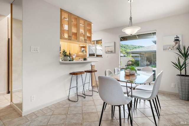 dining room featuring light tile patterned floors and baseboards
