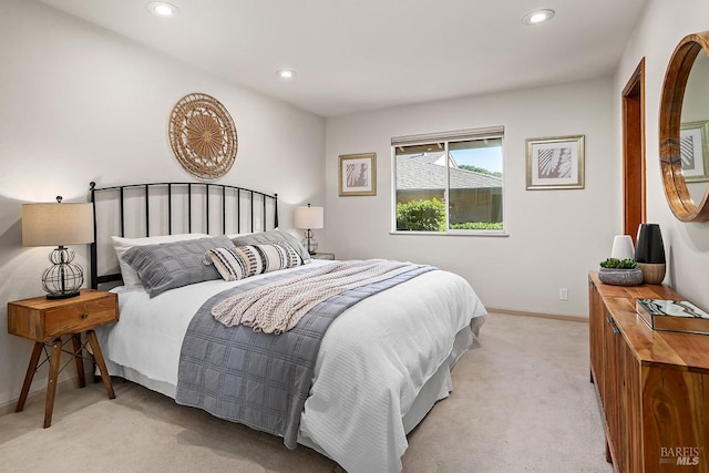 bedroom featuring baseboards, recessed lighting, and light carpet