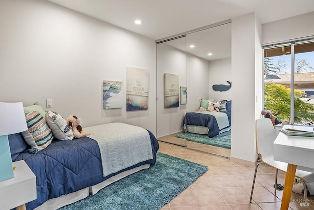 bedroom featuring recessed lighting, baseboards, light tile patterned floors, and a closet