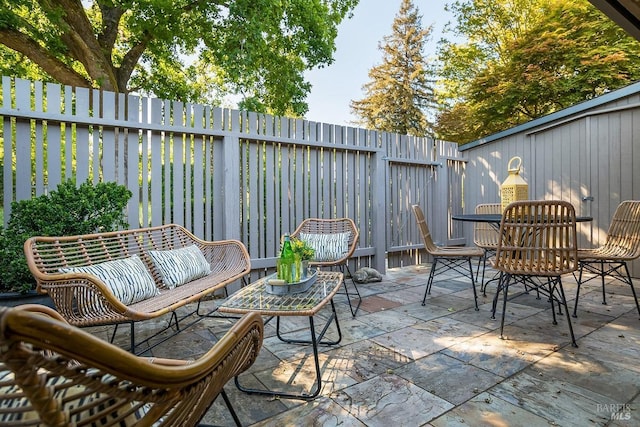 view of patio with a fenced backyard and outdoor dining space