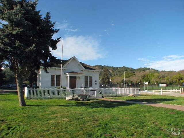 bungalow-style house with fence private yard and a front yard