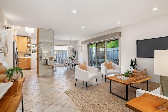 living area featuring recessed lighting and light tile patterned floors