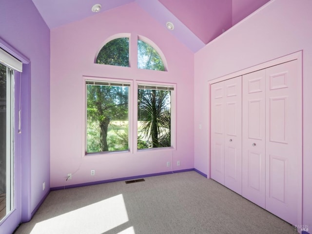 unfurnished bedroom with carpet flooring, visible vents, and multiple windows