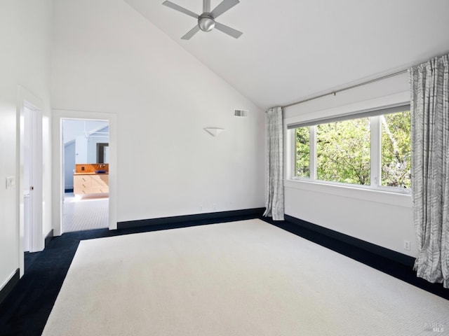 unfurnished room featuring ceiling fan, visible vents, high vaulted ceiling, baseboards, and dark colored carpet