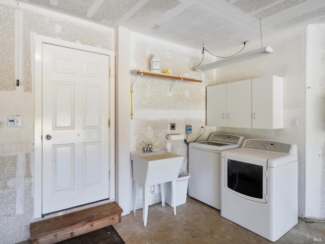washroom featuring cabinet space and washing machine and dryer