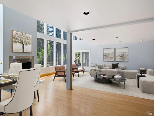 living room featuring recessed lighting, light wood finished floors, baseboards, and a fireplace