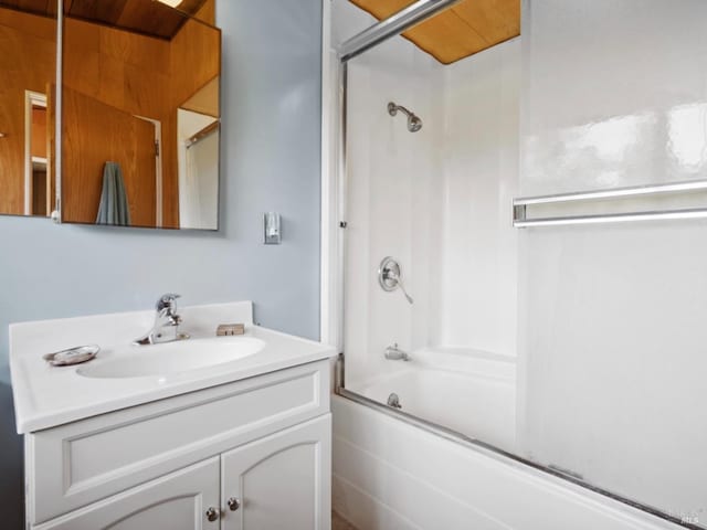 bathroom with vanity and combined bath / shower with glass door