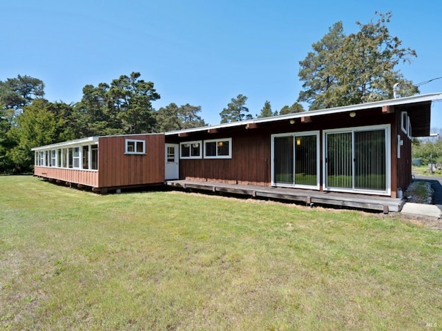 back of property with a lawn