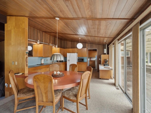 dining room featuring wood ceiling, visible vents, wood walls, lofted ceiling, and light carpet