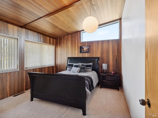 carpeted bedroom featuring visible vents, wood walls, and wooden ceiling