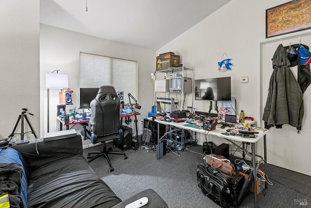 carpeted home office featuring vaulted ceiling