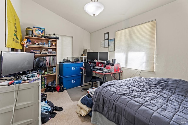 bedroom with vaulted ceiling and carpet