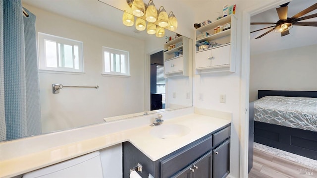 bathroom featuring vanity, ensuite bathroom, a ceiling fan, and wood finished floors