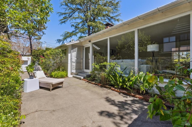 view of patio featuring a sunroom