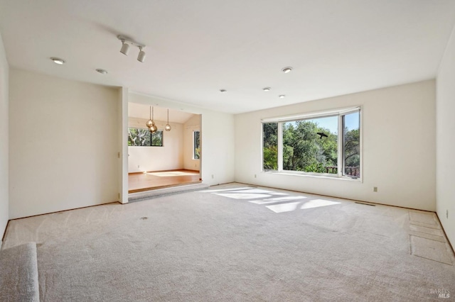 spare room with carpet flooring and visible vents