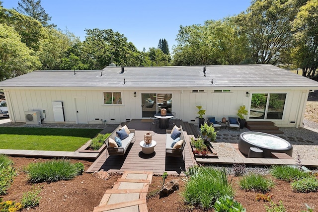 rear view of house featuring ac unit, a wooden deck, board and batten siding, outdoor lounge area, and a patio area