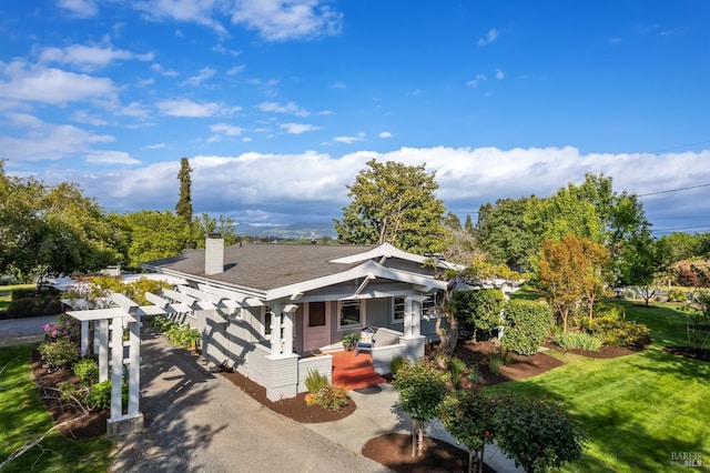 2855 Old Gravenstein Hwy, Sebastopol, CA 95472 - view of front of house featuring covered porch, a chimney, a front yard, and roof with shingles