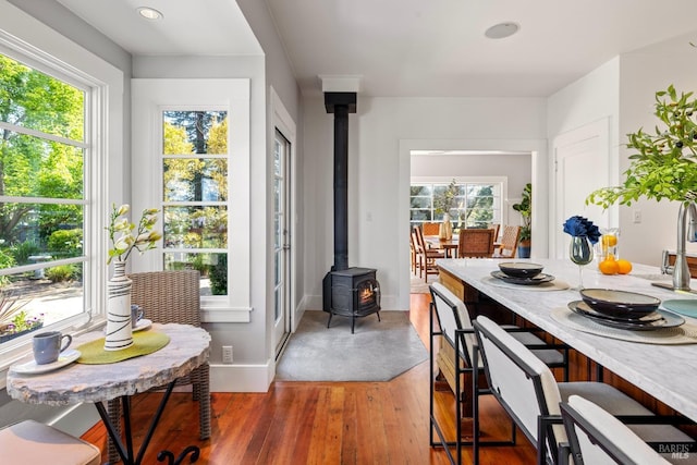 2855 Old Gravenstein Hwy, Sebastopol, CA 95472 - dining room featuring a wood stove, plenty of natural light, light wood-style floors, baseboards, and recessed lighting